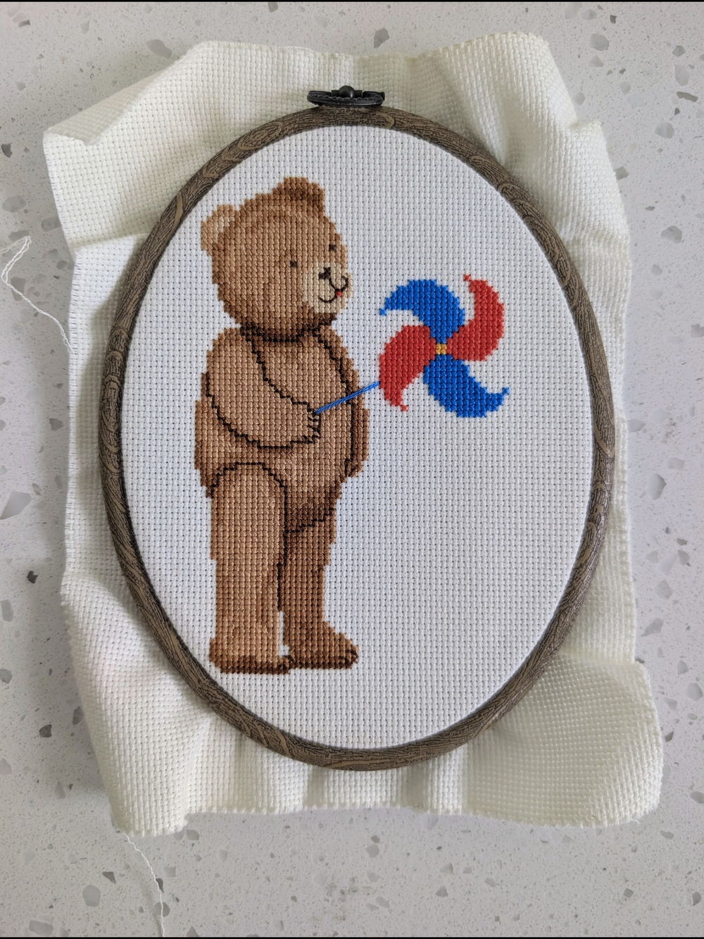Handmade Brown Teddy Bear Cross Stitch with Red & Blue Pinwheel